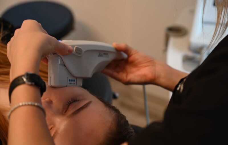 Technician with gloves preparing Ultherapy on patient